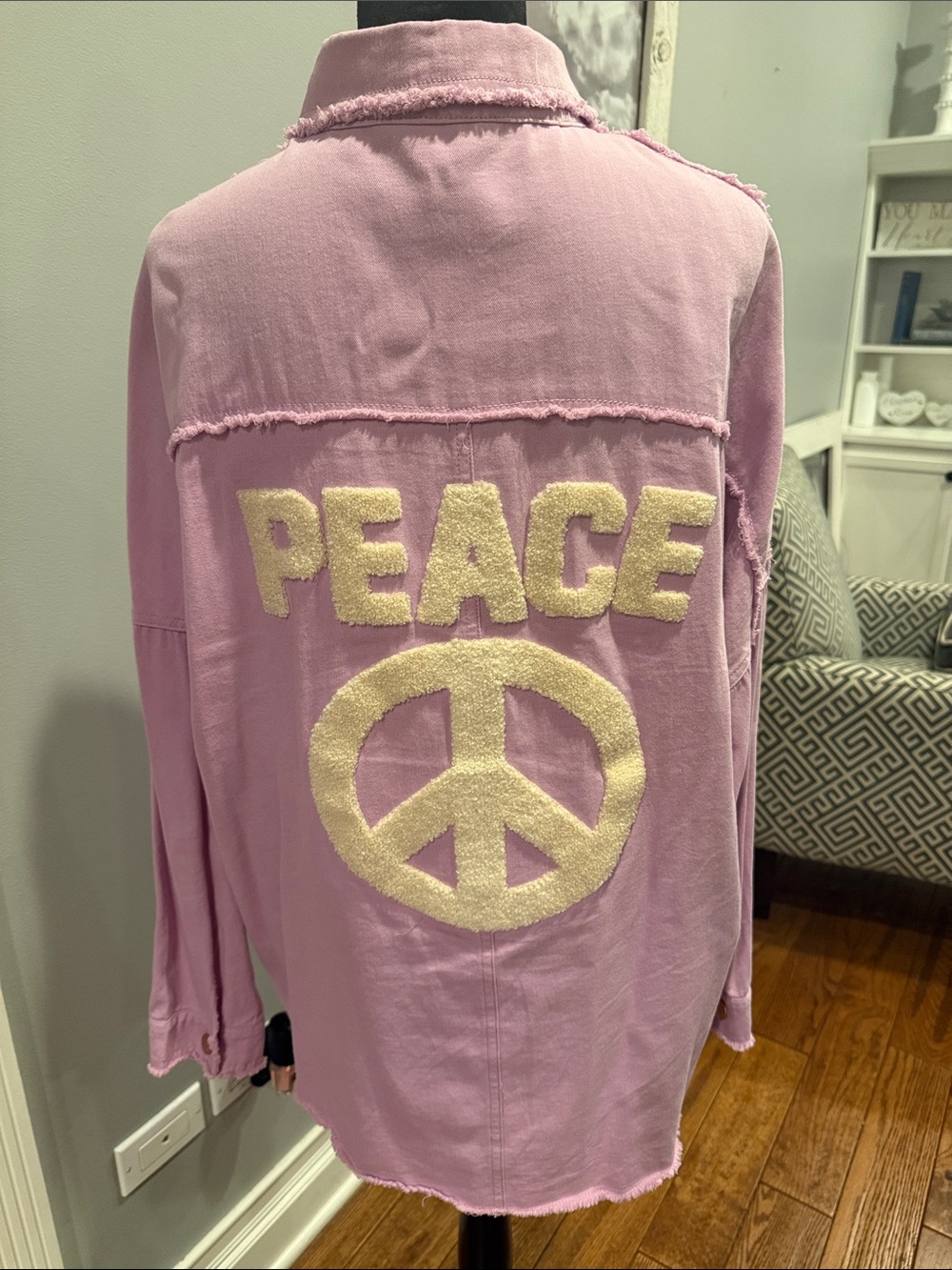 Lavender colored button down shirt with Peace on back.